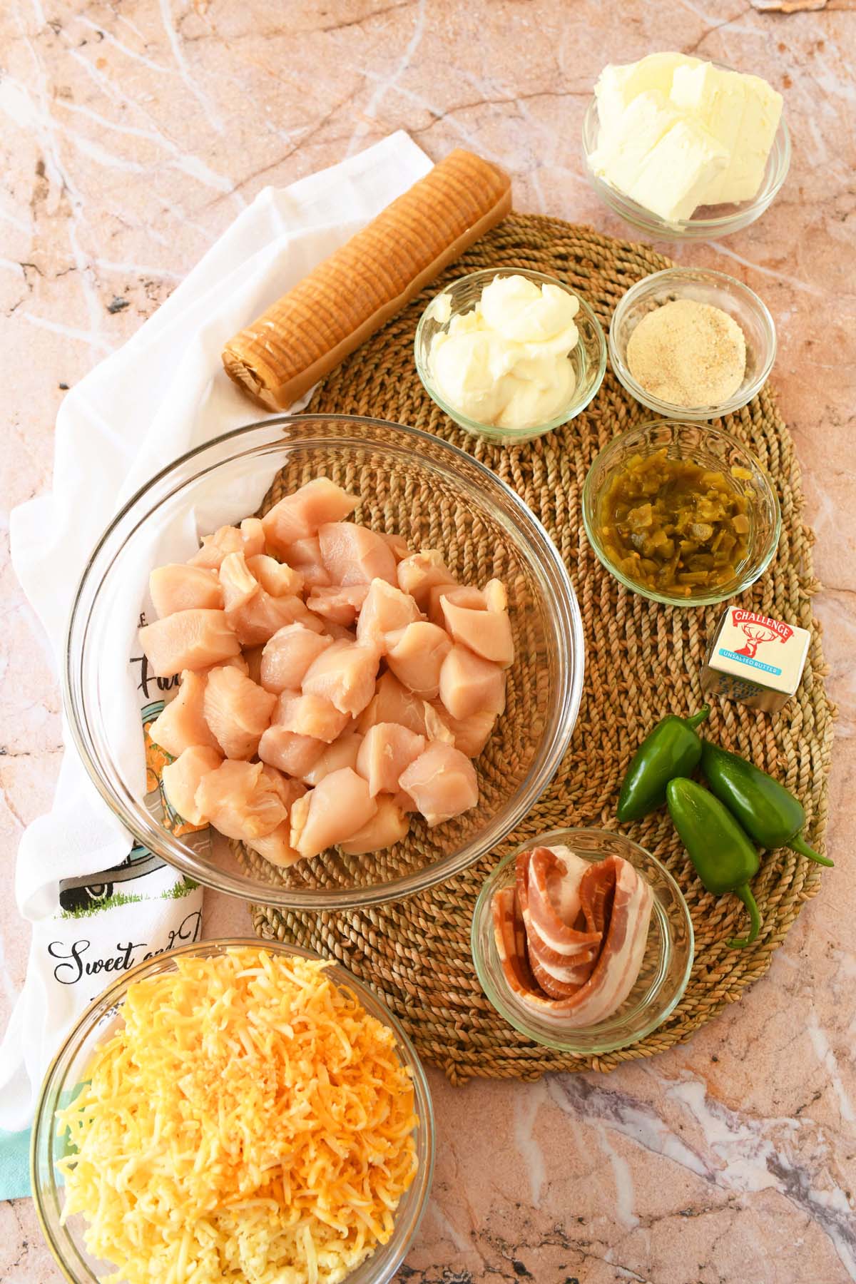 Jalapeno popper ingredients on a wicker placement.