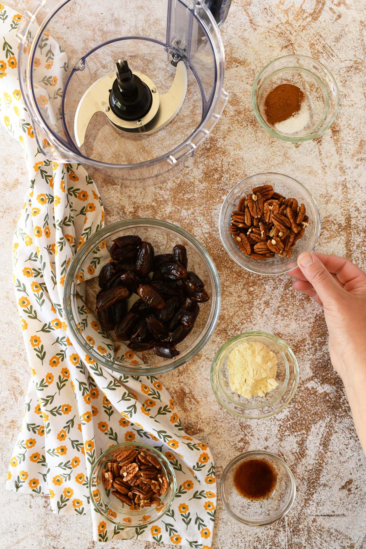 Pecan dat eenergy bite ingredients in small glass dishes.