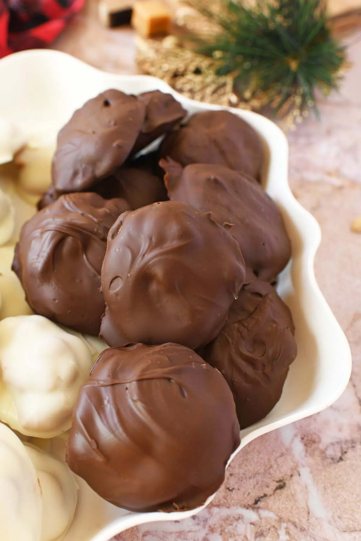 Semi-sweet peanut caramel clusters on a white tray.