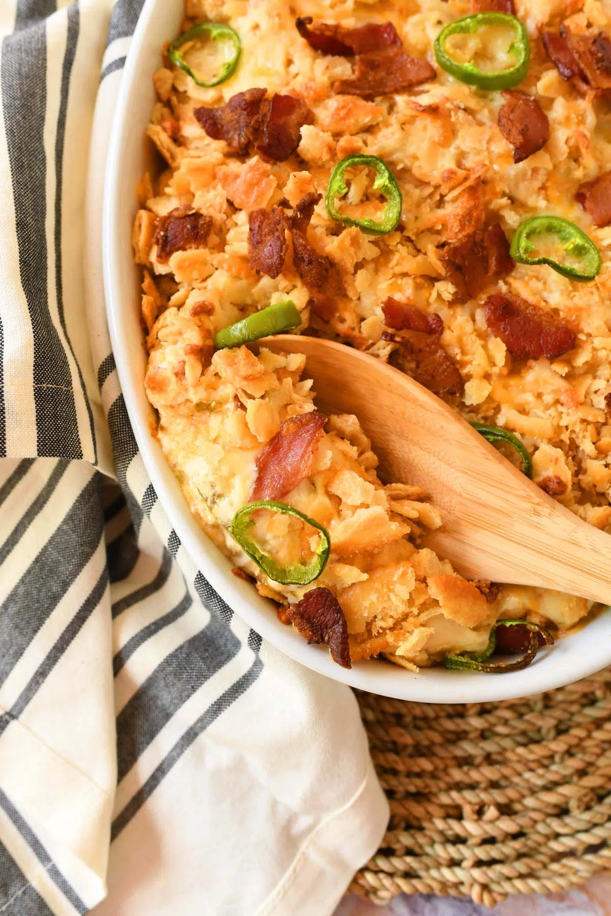 A wooden spoon with a scoop of jalapeno chicken bake.