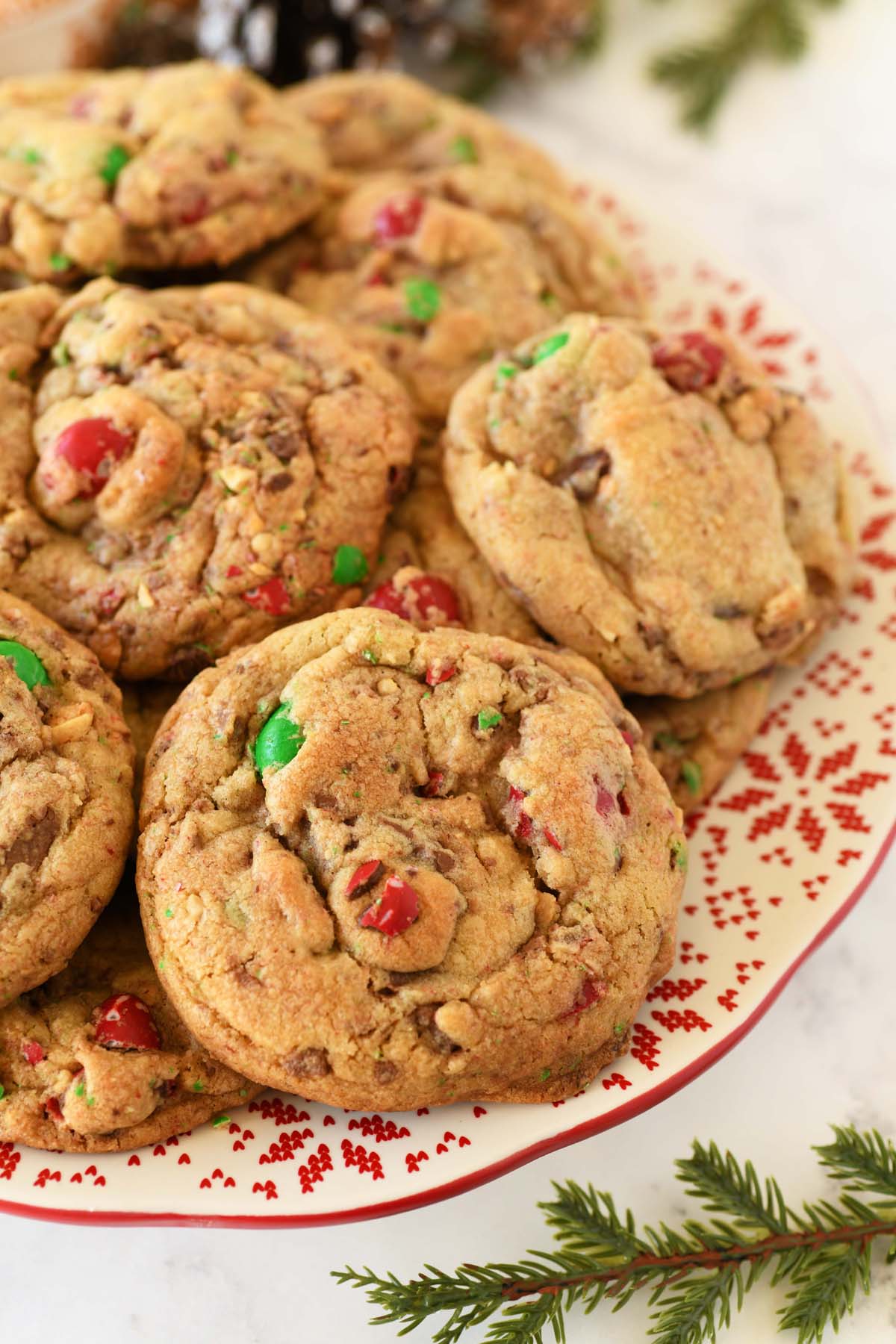Up close shot of large holiday cookies near greenery.