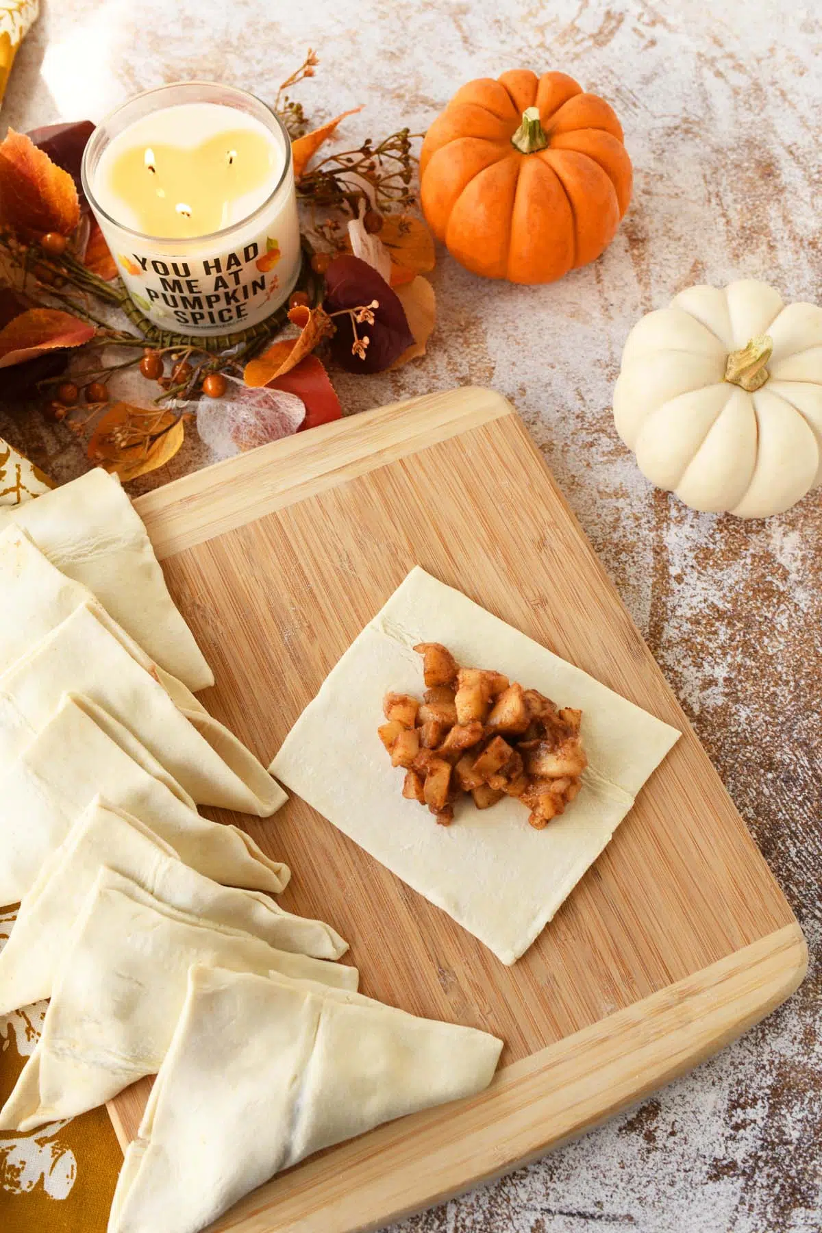 Apple pie filling in the middle of a slice of puff pastry.