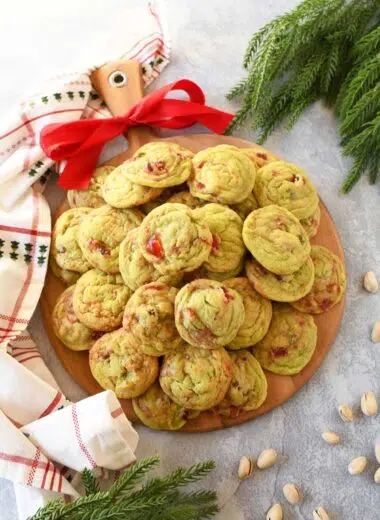 A tray of pistachio cherry cookies with a red bow.