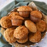 sourdough coffee cake muffins in a basket near a green napkin.