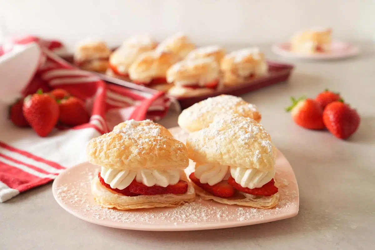Heart-shaped puff pastry on a pink, heart plate.