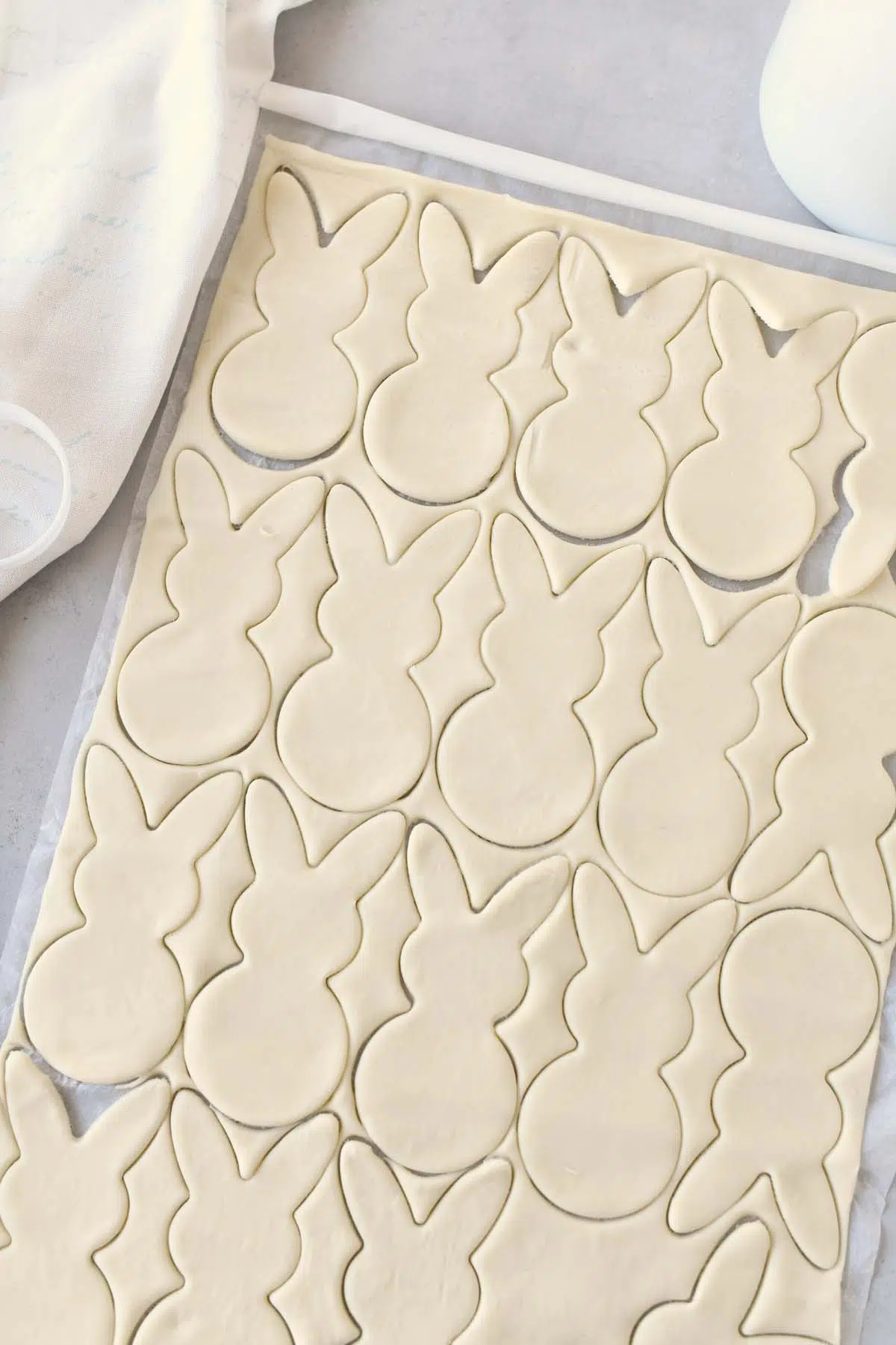 Puff pastry with bunny cutouts near a white napkin.
