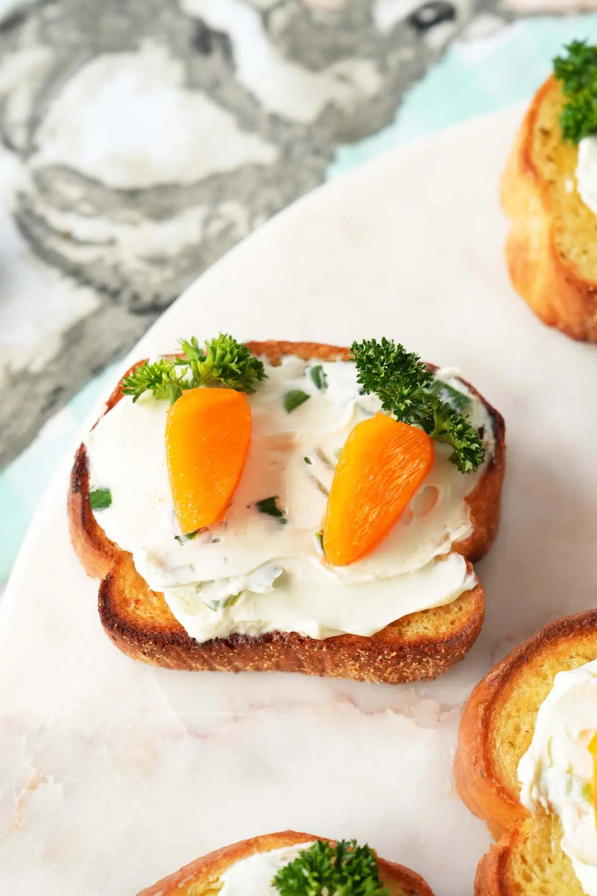 A up-slose shot of carrot patch toasts on a marble tray.