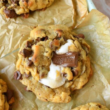 Oeey, Gooey, S'mores jumbo cookies on a parchment-lined baking sheet.