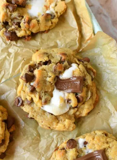 Oeey, Gooey, S'mores jumbo cookies on a parchment-lined baking sheet.