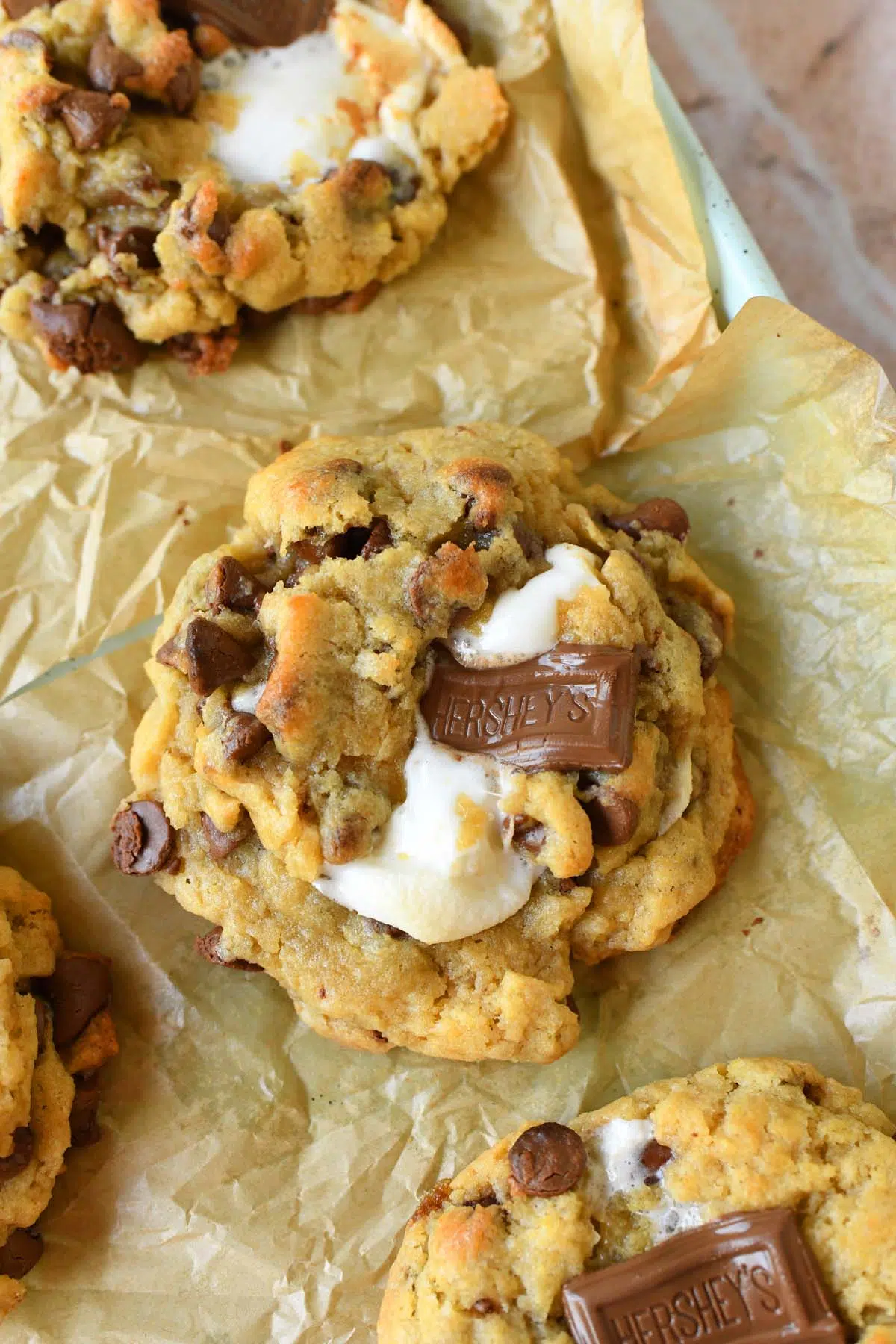 Oeey, Gooey, S'mores jumbo cookies on a parchment-lined baking sheet.